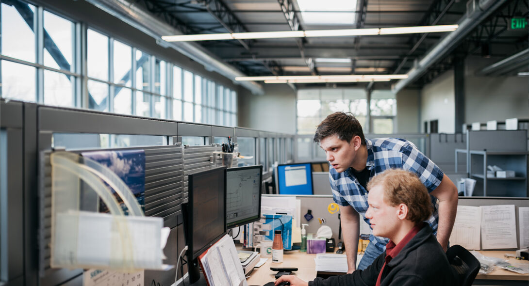 Two team members collaborating at a desk